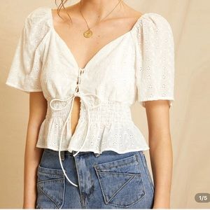 Lace up white shirt.